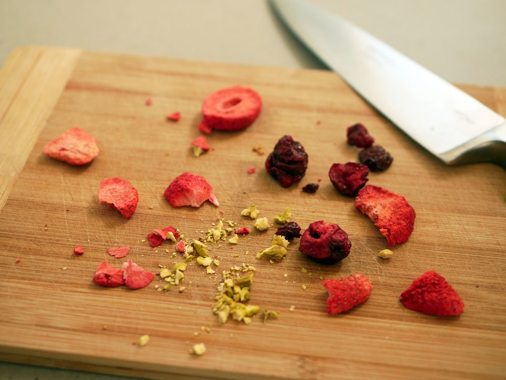 Cutting red dried fruit and pistachios